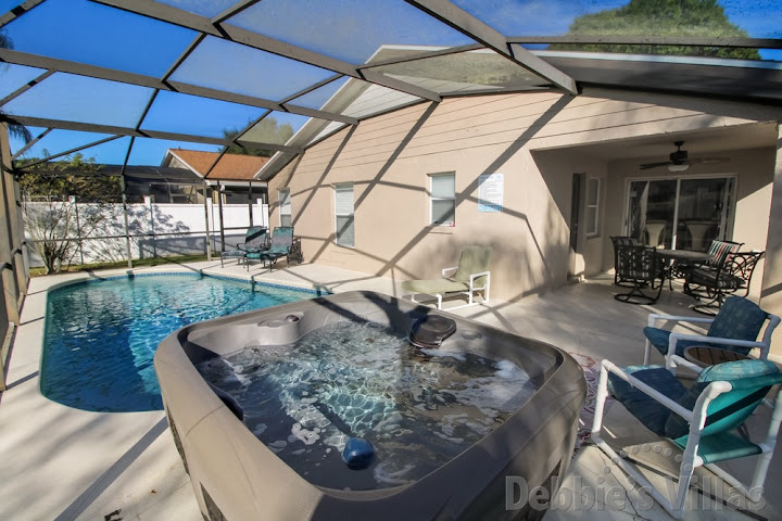 Enjoy a relaxing soak in the hot tub of this Kissimmee villa