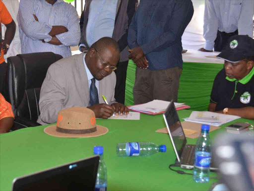 ODM candidate Ochilo Ayacko signs the IEBC clearance form for the Migori Senator by-election, August 9, 2018. /MANUEL ODENY