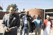 VICTORIOUS: Clifford Pillay and the evicted residents of Putfontein leave the Benoni magistrate's court after the Ekurhuleni municipality was ordered to rebuild their makeshift shelters near Chief Albert Luthuli township in Benoni. Pic: VATHISWA RUSELO. 05/05/2010. © Sowetan.

Clifford Pillay and the community of  Putfontein leaving the benoni magistrates court after the judge ordered the Ekurhuleni municipality to re build their makeshift shelter near Albert Luthuli Park in Benoni. PHOTO: VATHISWA RUSELO