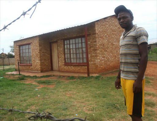 Themba Lesomo next to his grandmother's RDP house. PHOTO: ANTONIO MUCHAVE/SOWETAN