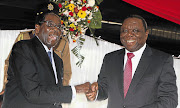 Zimbabwe President Robert Mugabe jokes with Prime Minister Morgan Tsvangirai after signing Zimbabwe's new constitution into law in Harare. File photo.