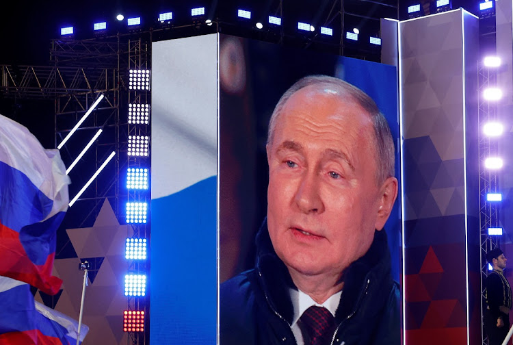 Russian incumbent President Vladimir Putin, who was declared winner of the presidential election by the country's electoral commission, is seen on a screen on the stage in Red Square in central Moscow on March 18 2024. Picture: REUTERS/Maxim Shemetov