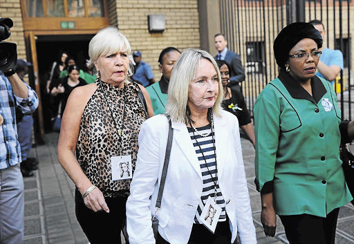 HARD EVIDENCE: June Steenkamp, Reeva's mother, centre, leaves the Pretoria High Court yesterday after listening to unhappy messages her daughter sent murder accused Oscar Pistorius