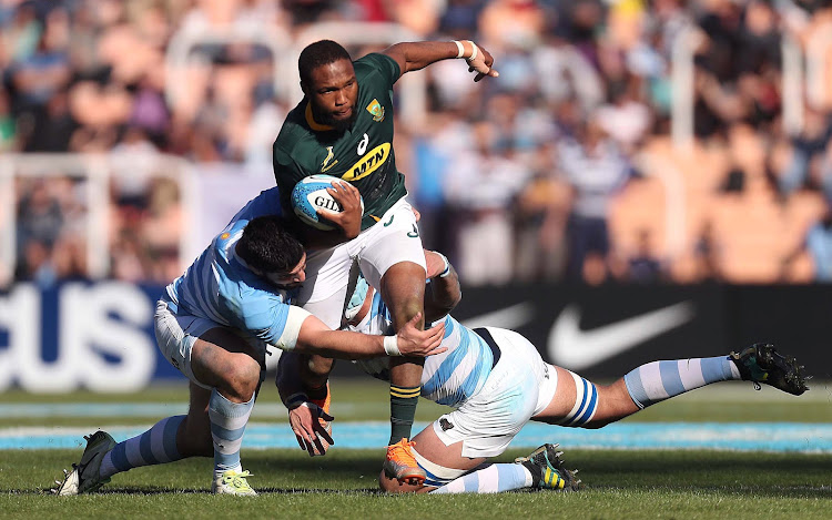 South Africa's Lukhanyo Am is tackled by Argentina's Agustin Creevy (L) and Tomas Lavanini during the Rugby Championship match at Malvinas Argentinas Stadium in Mendoza, on August 25, 2018.
