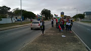 A small group has gathered in Cape Road, Mill Park.