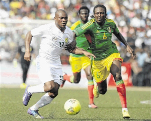 GETTING STUCK IN: Bafana striker Tokelo Rantie, left, battles with Congo's Bissiki Davy during their Africa Cup of Nations qualifier at Stade Municipal in Pointe Noire, Congo, on Saturday afternoon. Rantie scored Bafana's second goal Photo: Muzi Ntombela/BackpagePix