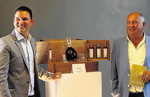 WELL SPENT: Peter Pitsiladi and his father Nicholas show off their brandy collection at the Nederburg wine auction