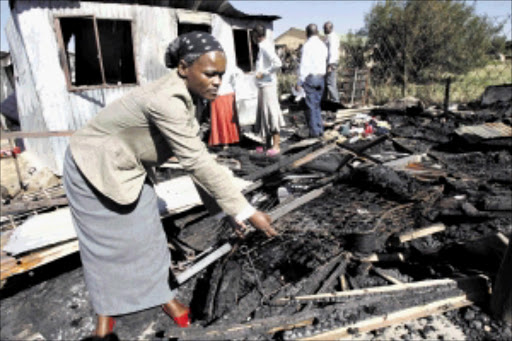 SAD BLOW: Helen Phaka lost her 11-month-old baby when her shack burned down in Ivory Park on Wednesday. Pic: ANTONIO MUCHAVE. 19/05/2010. © Sowetan.