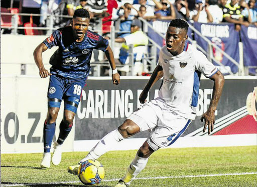 IN FULL CONTROL: Zitha Macheke of Chippa United, right, keeps the ball in play during the PSL match against Ajax Cape Town at the Nelson Mandela Bay Stadium in Port Elizabeth yesterday. The game ended in a draw Picture: GALLO IMAGES