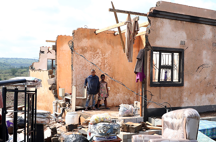 Bandile and Asanda Xulu outside their grandmother's home in eMpolweni, which collapsed after being hit by a tornado last month. Bad weather is again predicted for the province,