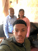 Gift Links  at home on holiday with his parents, Jacob and Dikeledi.