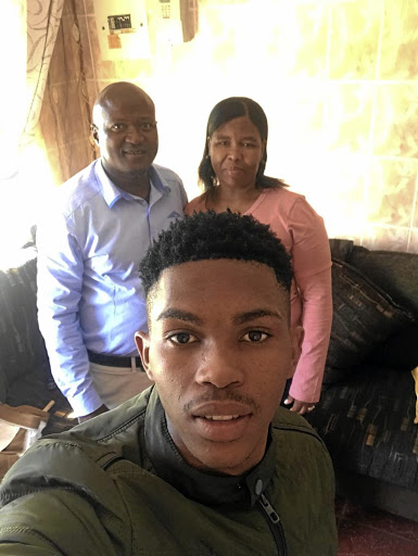 Gift Links at home on holiday with his parents, Jacob and Dikeledi.