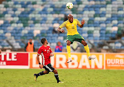 Bafana Bafana's Sifiso Hlanti heads  the ball with Libya's  Anias Sabbouof during their Africa Cup of Nations qualifier  at Moses Mabhida Stadium in Durban. 