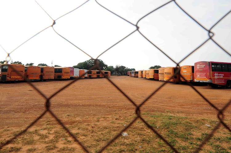 Putco buses parked at a depot.