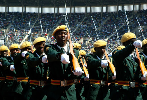 Members of the Zimbabwean national army march past on a parade inspected by Zimbabwean President Robert Mugabe on August 14, 2012 during the Defence Forces Day celebrations at the National Sports Stadium in Harare.