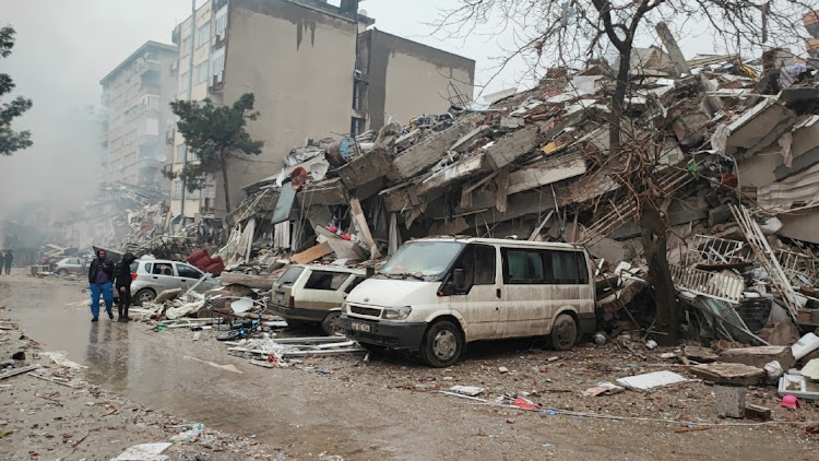 People in front of collapsed buildings after the earthquake in Kahramanmaras, Turkey on February 6 2023. File photo.