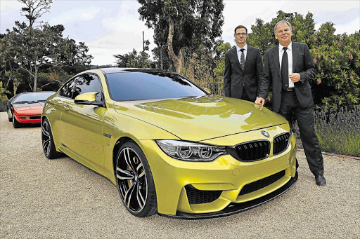 BMW M4 exterior designer Florian Nissl, left, and Dr Friedrich Nitschke, president BMW M Division at the BMW Concept M4 coupé showing at Pebble Beach, California