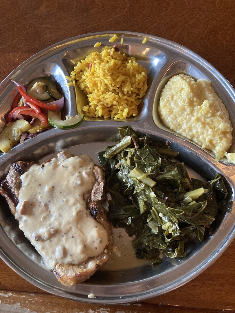 Sunday dinner alternating menu. This specific pork chop not a regular menu item, but there is another pork chop on the regular menu. Vegetables, yellow rice, grits, and collard greens as sides.