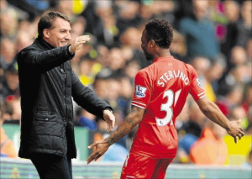 TARGET MAN: Raheem Sterling of Liverpool celebrates scoring a goal with his manager Brendan Rodgers during their Premier League match against Norwich City. The Reds could tour SA next month Photo: Michael Regan/Getty Images