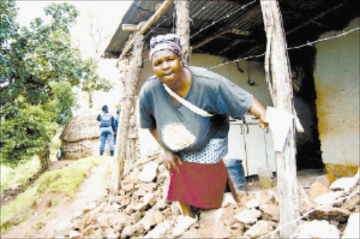 DESTROY ED: Kiki Zulu shows the damage caused by the storm to her home on New Year 's Day. Pic: THULI DLAMINI. 04/01/2010. © Sowetan.