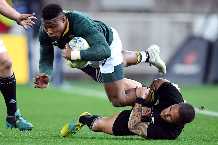 South Africa's Aphiwe Dyantyi is tackled by New Zealand's Aaron Smith on his way to scoring during a Rugby Championship match between the Springboks and New Zealand at Westpac Stadium in Wellington on September 15, 2018.