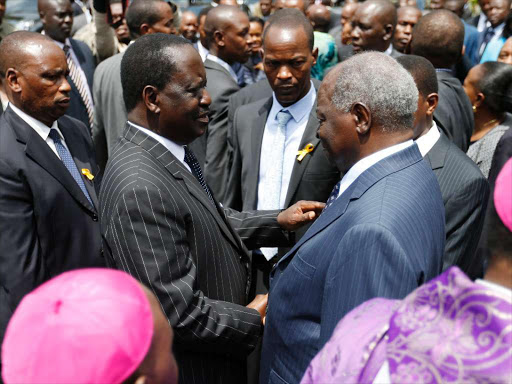 Cord leader Raila Odinga consoles former President Mwai Kibaki during the requiem mass for former First Lady Lucy Kibaki at the Consolata Shrine in Westlands, Nairobi, on May 4 /JACK OWUOR