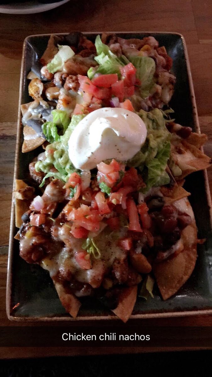 Chicken chili nachos. Gluten free fried chips and tons of toppings including guacamole, cheese, vegan chili, beans, chicken, pico de Gallo and I’m sure I’m forgetting something. But super delicious