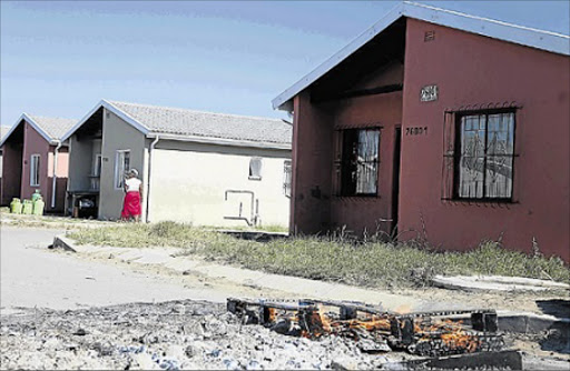 Angry shack dwellers Ndancama residents vandalised new RDP homes near Scenery Park yesterday claiming unfair housing allocation process Picture: SIBONGILE NGALWA