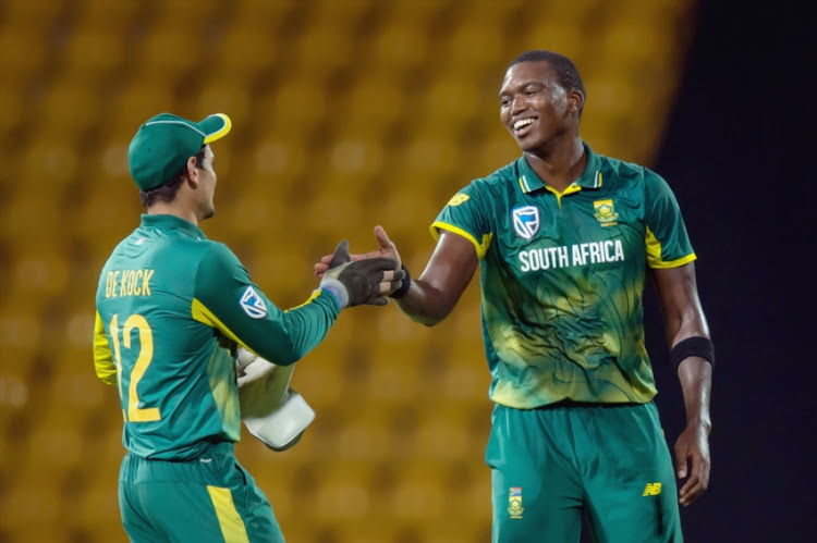 Lungi Ngidi (R) of South Africa celebrates the wicket of Dhanajaya De Silva of Sri Lanka (not in picture) with Quinton de Kock (L) Captain of South Africa during the 4th ODI between Sri Lanka and South Africa at Pallekele International Cricket Stadium.