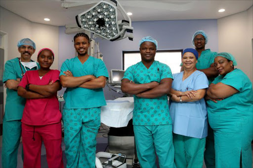 TEAM EFFORT: Anaethetists Dr Anantha Bhat & Dr Yakheka Dyasi with Paediatric Surgery Team's Dr Sello Machaea and Dr Mzwandile Jula, Sisters Ellen Bentley and Joyce Poponi with Dr Dumisani Majombozi Picture: MARK ANDREWS
