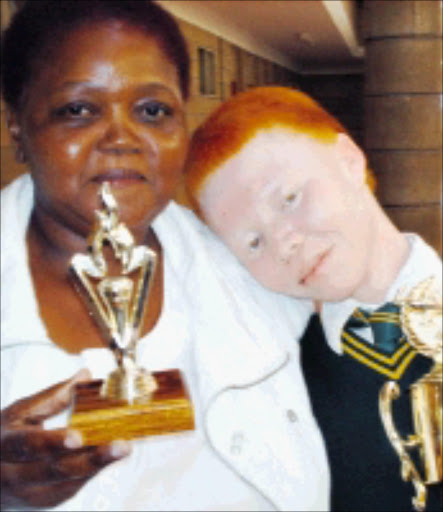 WELL DONE: Khanyisa School for the Visually Impaired English teacher Mandisa Buwa congratulates Sisanda Ngcana, who won the 2008 National Schools Essay Competition on Albinism. 24/02/09. Pic. Victor Mecoamere. © Sowetan.