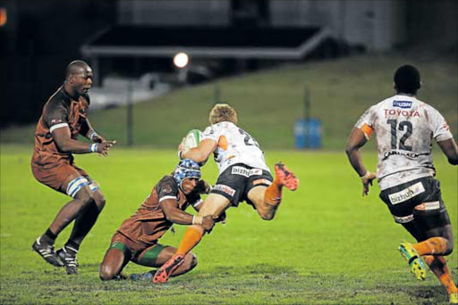 STANDING FIRM: Border Bulldogs’ Masixole Banda tackles Free State’s Gerrie Labuschagne during the game on Friday evening at Buffalo City Stadium Picture: MARK ANDREWS