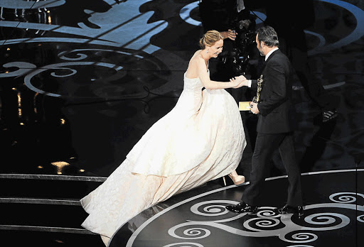 Jennifer Lawrence going up to the stage to accept the Oscar for Best Actress for 'Silver Linings Playbook'.
