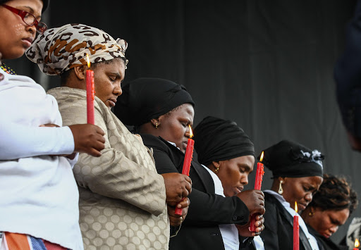 16 August 2014 Miners gathered at the Kopie to commemorate the second anniversary since the police killed the 34 miners during the strike in Marikana. The Marikana widows carried candles during the event. File photo