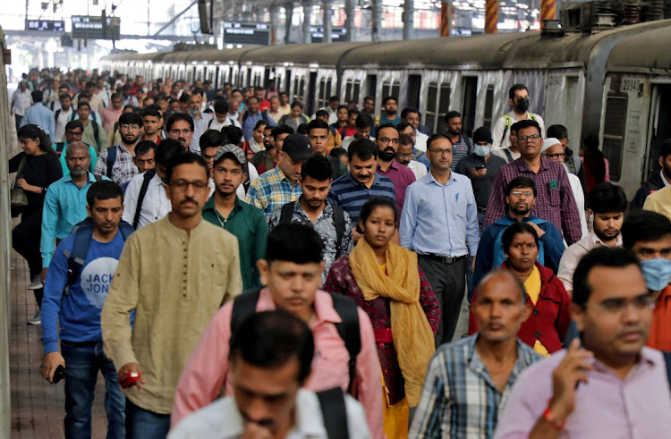 Commuters walk on a platform after disembarking from a suburban train at a railway station in Mumbai, India, January 21 2023. Picture: REUTERS/Niharika Kulkarni