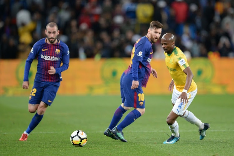 FC Barcelona superstar Lionel Messi and Tebogo Langerman of Mamelodi Sundowns during the International Club Friendly match between Mamelodi Sundowns and Barcelona FC at FNB Stadium on May 16, 2018 in Johannesburg, South Africa.