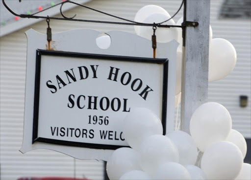 Balloons hang on a sign at the entrance to Sandy School on December 15, 2012 in Newtown, Connecticut. The residents of an idyllic Connecticut town were reeling in horror from the massacre of 20 small children and six adults in one of the worst school shootings in US history. The heavily armed gunman shot dead 18 children inside Sandy Hook Elementary School, said Connecticut State Police spokesman Lieutenant Paul Vance. Two more died of their wounds in hospital.