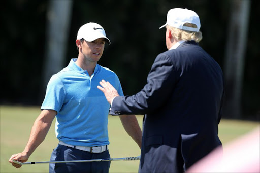 Republican presidential candidate Donald Trump makes an appearance prior to the start of play and speaks with golfer Rory McIlroy of Northern Ireland during the final round of the World Golf Championships-Cadillac Championship at Trump National Doral Blue Monster Course on March 6, 2016 in Doral, Florida.