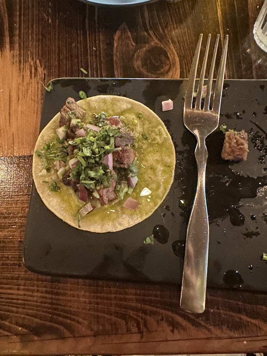 Carne asada tacos, smeared with guac with with a generous cilantro and onion topping. So good that you could eat a half dozen easily!