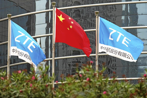 A Chinese national flag and two flags bearing the name of ZTE fly outside the ZTE research and development building in Shenzhen, China, in this 2016 file photo. Picture: REUTERS/Bobby Yip