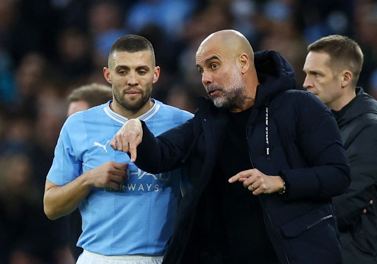 Manchester City manager Pep Guardiola gives instructions to Mateo Kovacic in their FA Cup quarterfinal win against Newcastle United at Etihad Stadium in Manchester, Britain on Saturday.