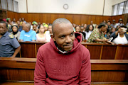 Thabani Mzolo smiles as he appears in the Durban Magistrate's Court  for the murder of ex-girlfriend   Zolile Khumalo.  