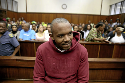 Thabani Mzolo smiles as he appears in the Durban Magistrate's Court for the murder of ex-girlfriend Zolile Khumalo.