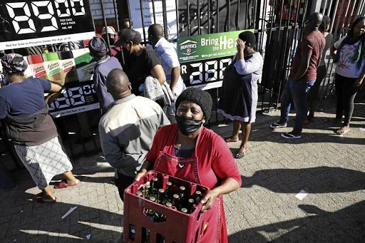 Young people had a strong presence in long queues for liquor on Monday. / ESA ALEXANDER