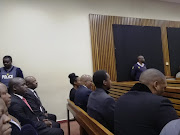 Former president Jacob Zuma (front, second from left, wearing spectacles) awaits the verdict in the culpable homicide trial of his son Duduzane Zuma.