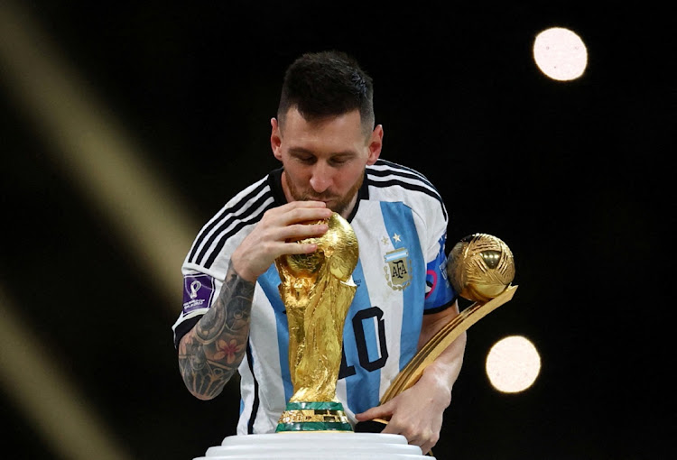 Argentina's Lionel Messi kisses the World Cup trophy after receiving the Golden Ball award as he celebrates after winning the 2022 Fifa World Cup in the final against France at Lusail Stadium in Lusail, Qatar on December 18 2022.