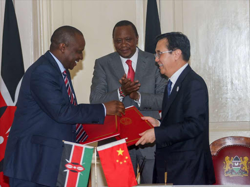 DEAL: National Treasury CS Henry Rotich exchanges bilateral agreements with Chinese minister for Commerce Gao Huncheng in the presence of President Uhuru Kenyatta at State House, Nairobi on December 16 last year. Photo/PSCU