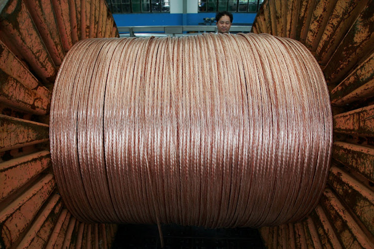 An employee at an electricity cable factory in Baoying, China. Picture: REUTERS/Aly Song/File Photo