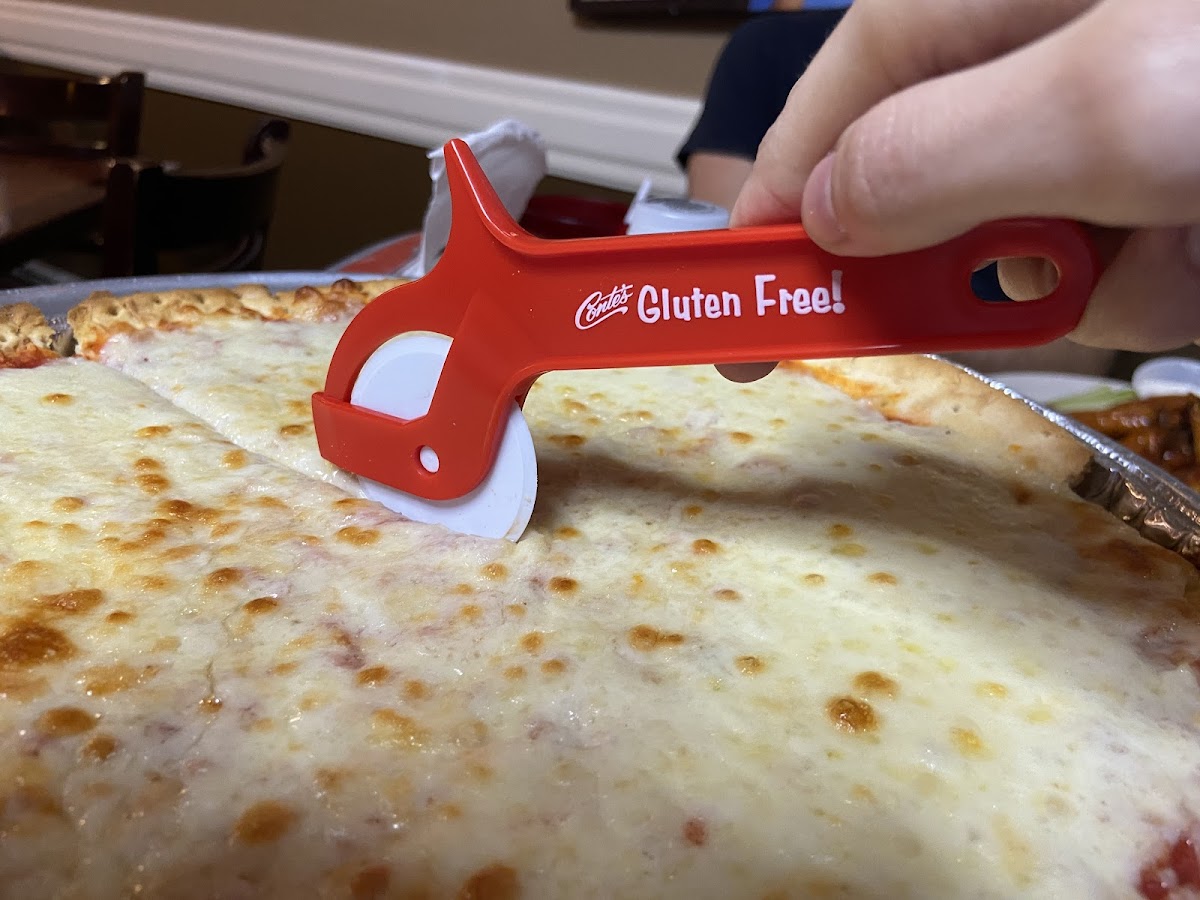 GF pizza comes with a sealed plastic pizza cutter.