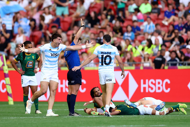 Matteo Graziano (left) and Tobias Wade of Argentina celebrate wining the men's fifth-place playoff match against the Blitzboks to take the overall 2023-24 HSBC Sevens title on during day three of the Singapore Sevens at the National Stadium in Singapore on Sunday.